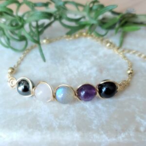 Empath bracelet in gold tone with amethyst, rose quartz, labradorite, hematite, and black tourmaline.