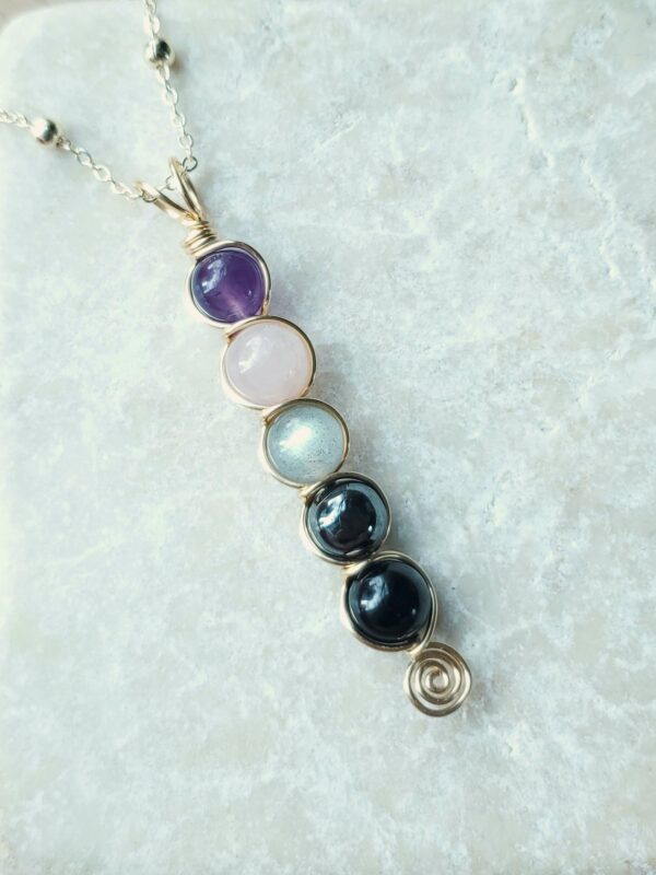 empath protection necklace with natural crystal stones of amethyst, rose quartz, labradorite, hematite, and black tourmaline.