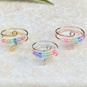 Gold, Silver, and Rose Gold anxiety rings with pastel rainbow beads