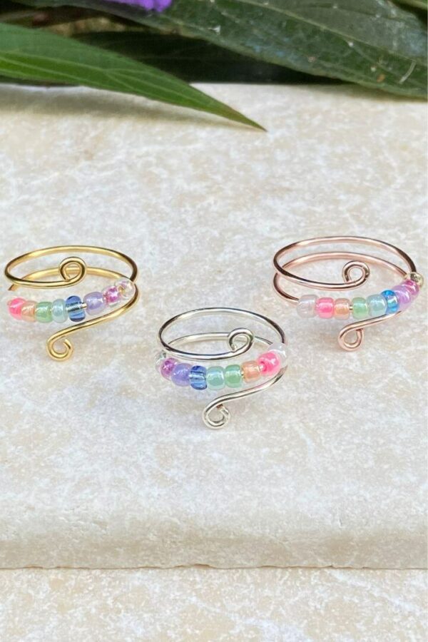 Gold, Silver, and Rose Gold anxiety rings with pastel rainbow beads