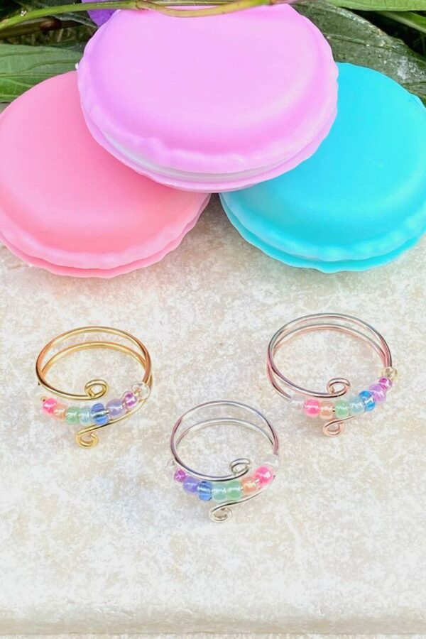 anxiety fidget rings with pastel rainbow beads and macaron container