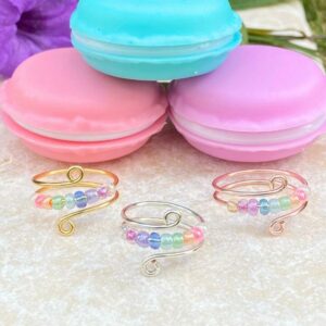 anxiety fidget rings with pastel rainbow beads and macaron container