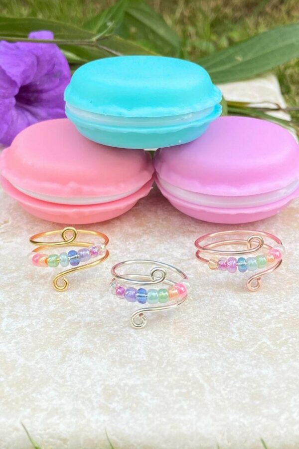 anxiety fidget rings with pastel rainbow beads and macaron container