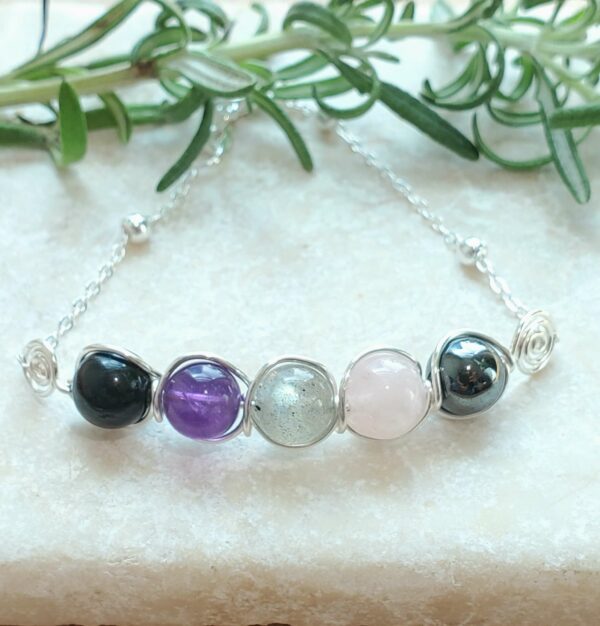 wire wrapped empath protection bracelet in silver tone.