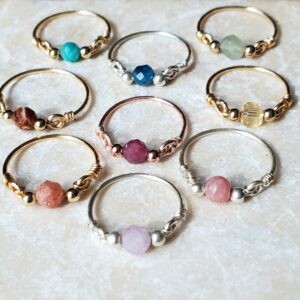 Natural gemstone crystal rings in various colors and designs.