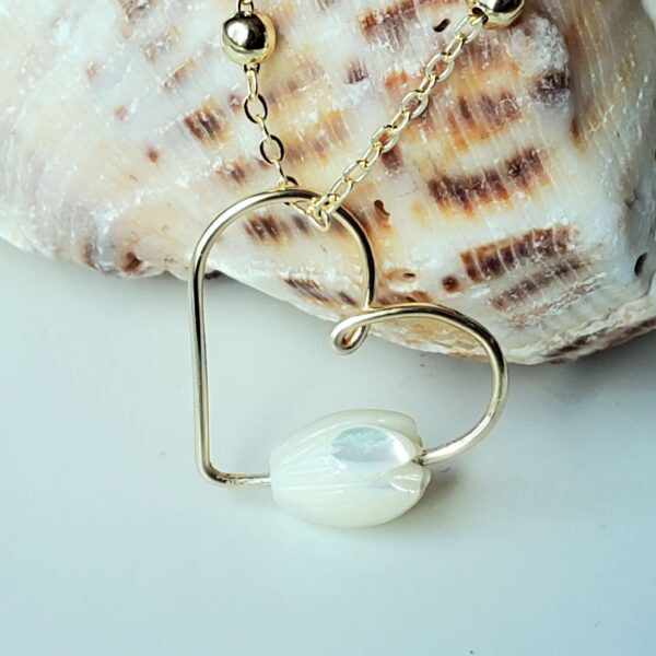 Handmade Crystal Heart Necklace featuring a Mother Of Pearl gemstone for love and healing.