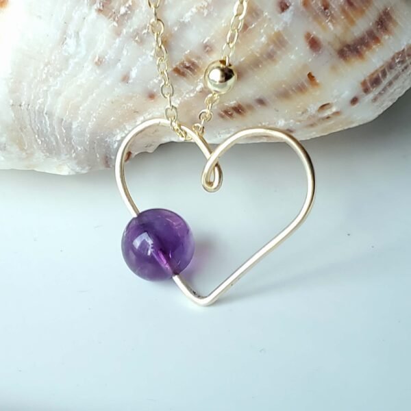 Handmade Crystal Heart Necklace featuring an Amethyst gemstone for peace and spiritual growth.