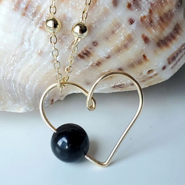 Black Tourmaline heart-shaped crystal gemstone necklace for grounding and protection.