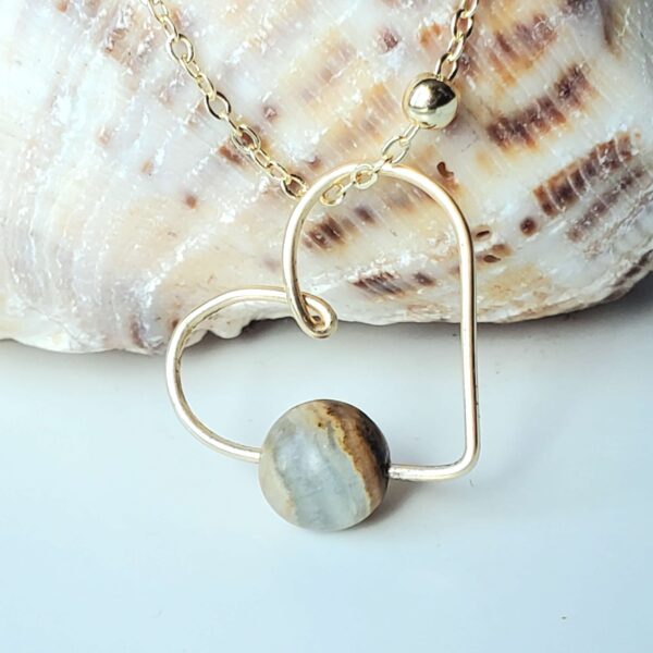 Handmade Crystal Heart Necklace featuring Blue Calcite gemstone for protection and confidence.