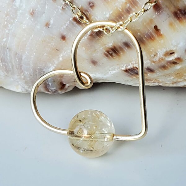 Handmade Crystal Heart Necklace featuring a Citrine gemstone for abundance and joy.