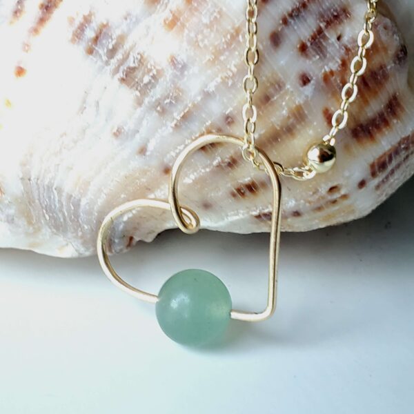 Green Aventurine heart-shaped crystal gemstone necklace for financial prosperity and abundance.