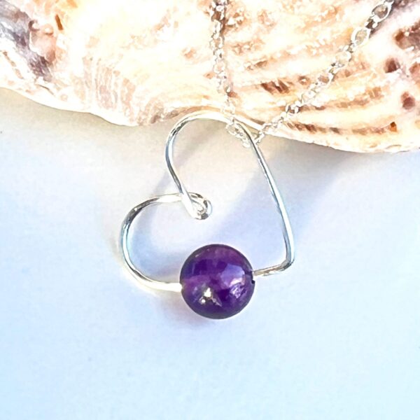 Handmade Crystal Heart Necklace featuring an Amethyst gemstone for peace and spiritual growth.