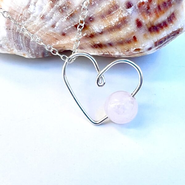 Handmade Crystal Heart Necklace featuring a Rose Quartz gemstone for love and healing.