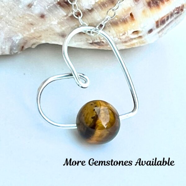 Handmade Crystal Heart Necklace featuring a Tiger's Eye gemstone for protection and confidence.