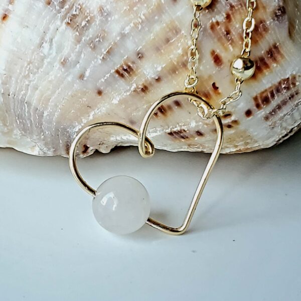 Handmade Crystal Heart Necklace featuring a Rose Quartz gemstone for love and healing.