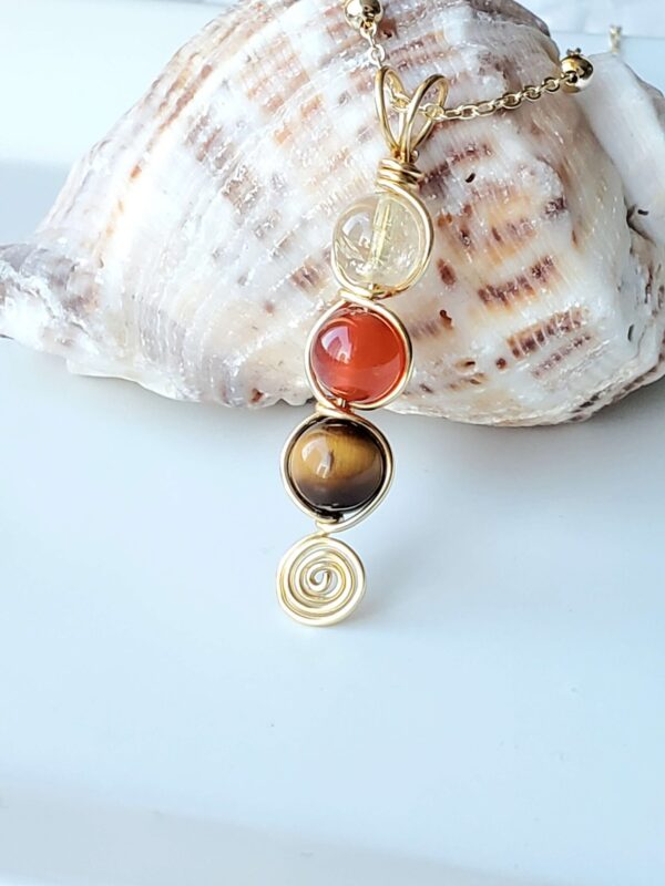 handmade wire-wrapped pendant featuring citrine, carnelian, and tiger's eye gemstones, designed to promote career success and goal manifestation.